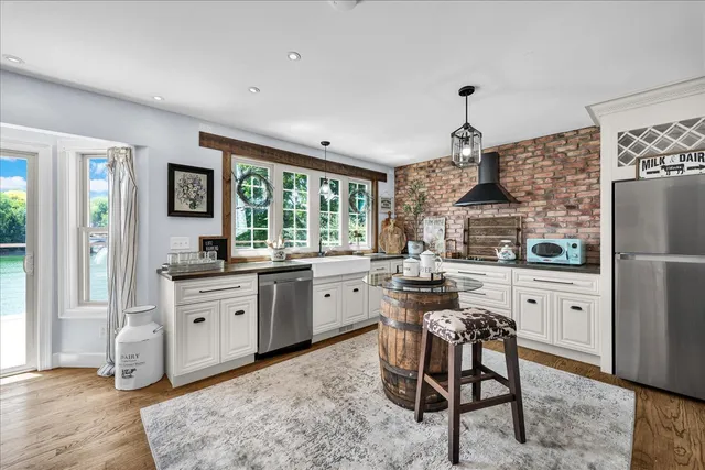 a kitchen with stainless steel appliances granite countertop a refrigerator and a stove top oven
