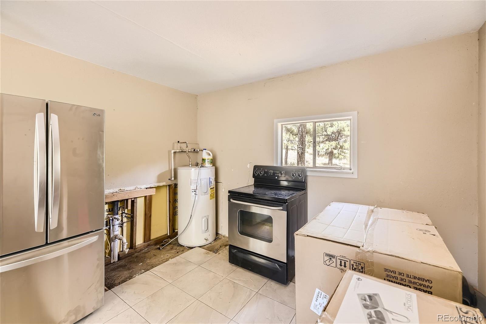 539 Neal Road Bailey, CO 80421 - Photo 7 of 26 a kitchen with a stove and a microwave