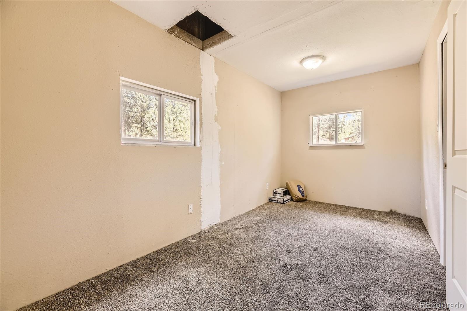 539 Neal Road Bailey, CO 80421 - Photo 8 of 26 an empty room with windows