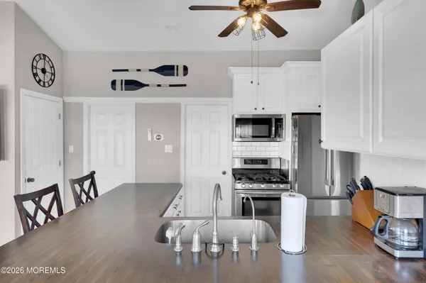 a kitchen with stainless steel appliances a stove a sink and cabinets
