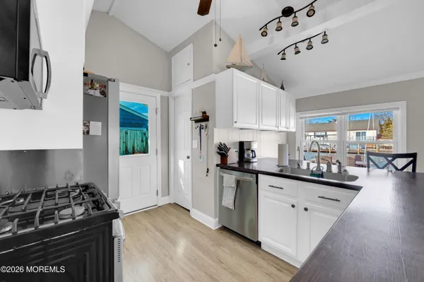 a kitchen with stainless steel appliances a sink stove and cabinets