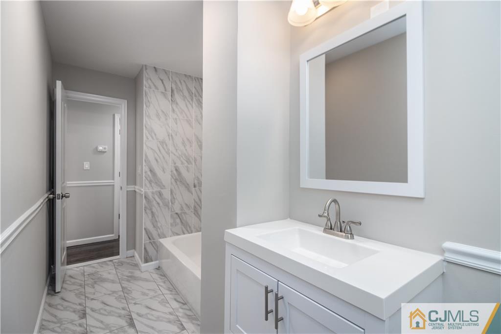 3034 Cheesequake Road Old Bridge, NJ 08859 - Photo 8 of 28 a bathroom with a sink and a mirror