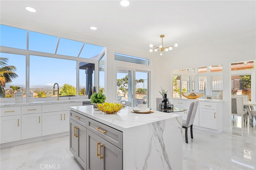 a kitchen with a sink cabinets and chairs