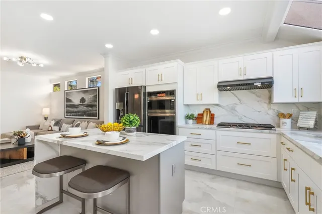 a kitchen with a sink stove and chairs
