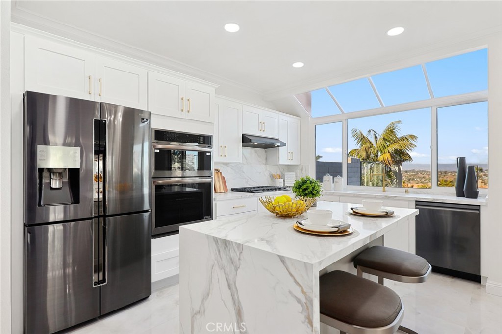 30352 Anamonte Laguna Niguel, CA 92677 - Photo 13 of 43 a kitchen with stainless steel appliances granite countertop a sink a stove and refrigerator