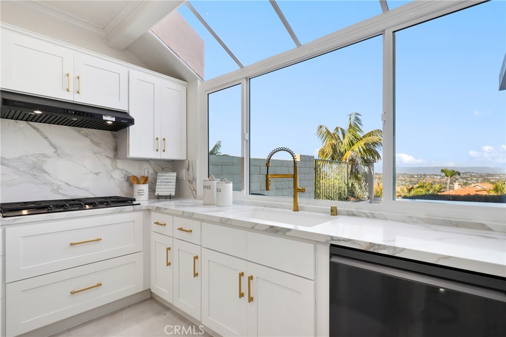 30352 Anamonte Laguna Niguel, CA 92677 - Photo 15 of 43 a kitchen with stainless steel appliances granite countertop a sink a stove and a microwave