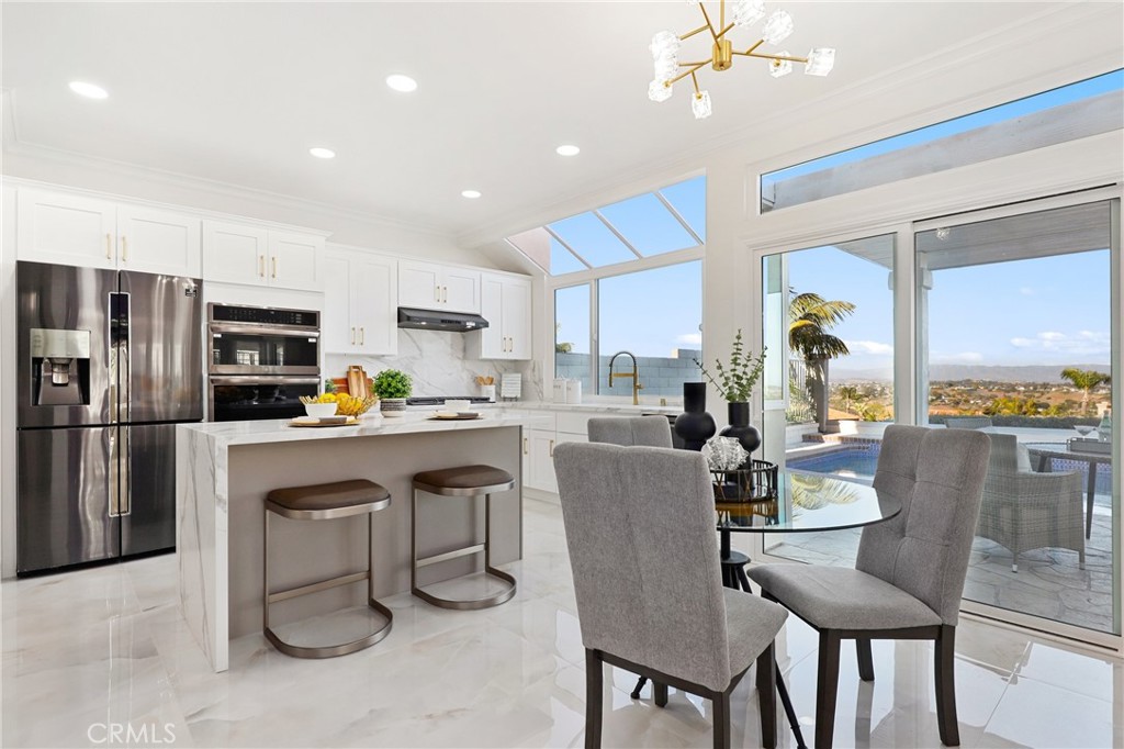 30352 Anamonte Laguna Niguel, CA 92677 - Photo 16 of 43 a kitchen with a dining table chairs and refrigerator