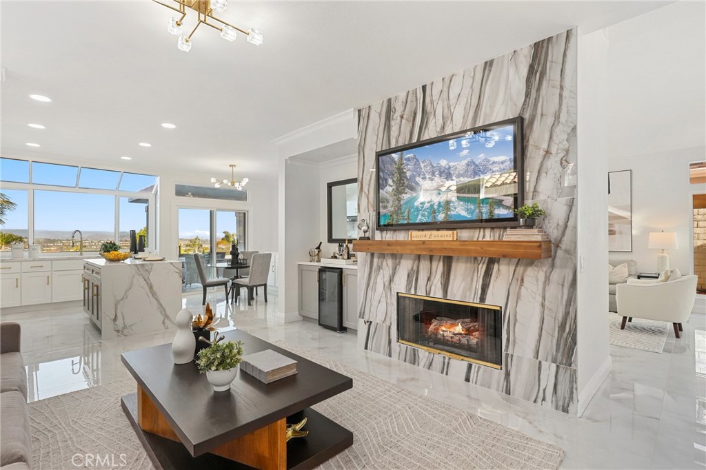 30352 Anamonte Laguna Niguel, CA 92677 - Photo 19 of 43 a living room with furniture a fireplace and kitchen view