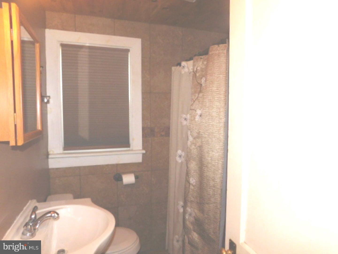 2447 Woodland Road Abington, PA 19001 - Photo 15 of 24 a bathroom with a sink and a mirror