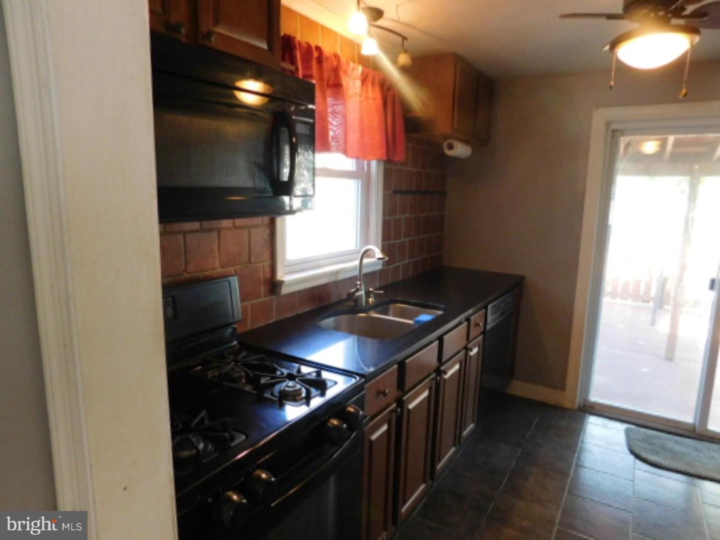 2447 Woodland Road Abington, PA 19001 - Photo 5 of 24 a kitchen with a stove and a microwave