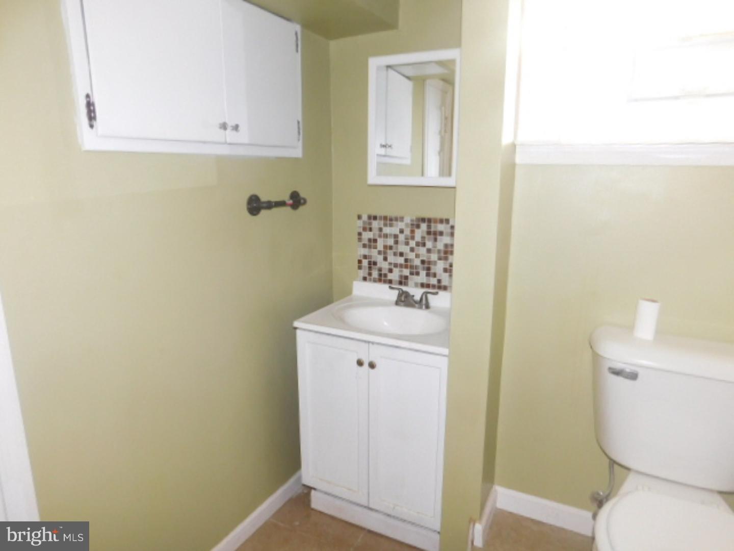 2447 Woodland Road Abington, PA 19001 - Photo 8 of 24 a bathroom with a toilet sink and vanity