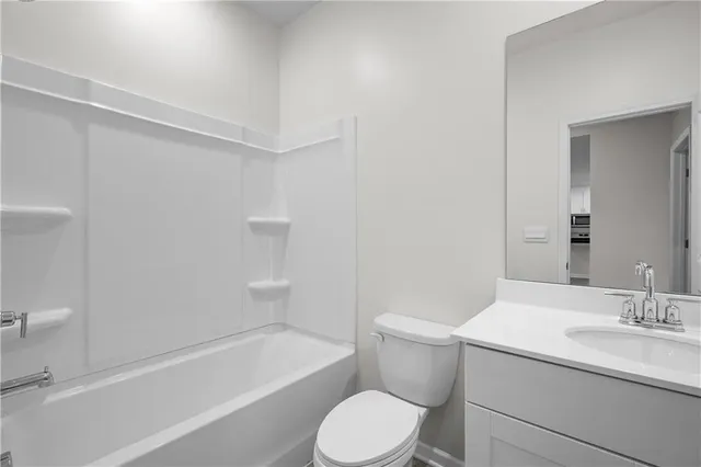 a bathroom with a sink toilet vanity and bathtub