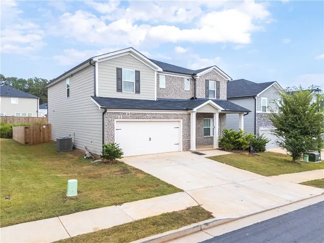 a front view of a house with a yard