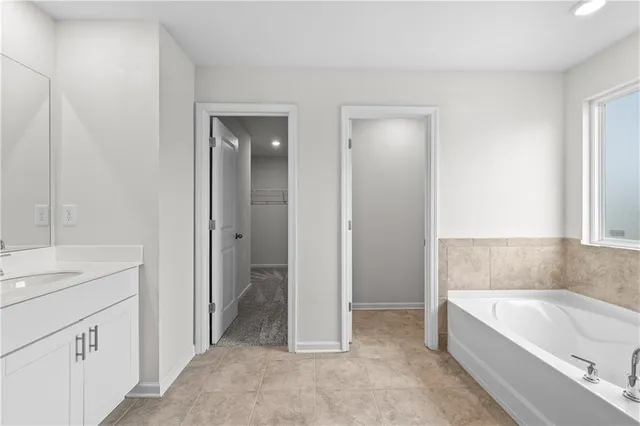 a bathroom with a bathtub and a sink