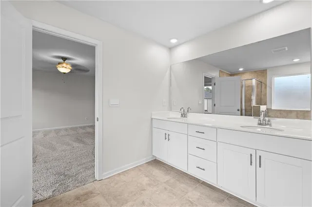 a bathroom with double sink and a mirror