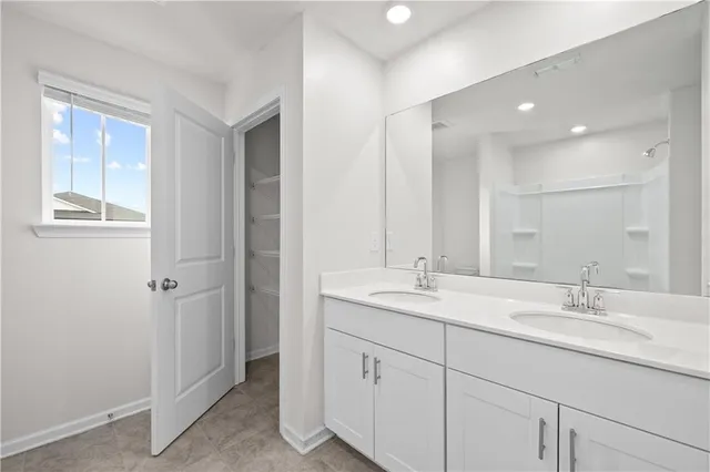 a bathroom with a double vanity sink and mirror