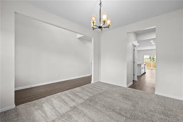 a view of a chandelier in big room and a chandelier fan