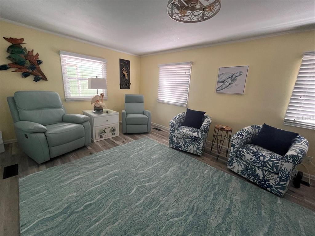 2295 North Beach Road, Unit 23 Englewood, FL 34223 - Photo 9 of 19 a living room with furniture and a window