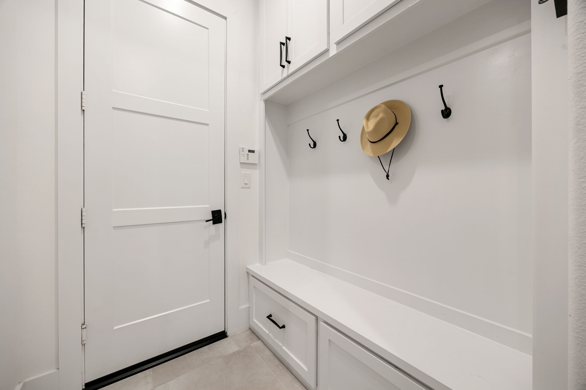 27903 Indigo Ridge Drive Fulshear, TX 77441 - Photo 27 of 50 Functional mudroom with built-in storage, bench seating, and custom cabinetry for everyday organization.