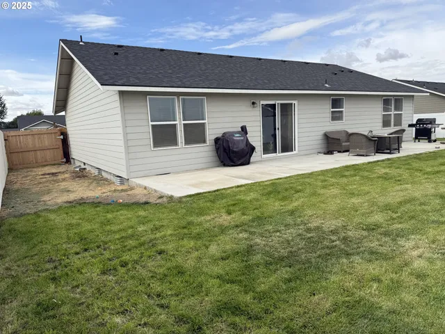 a front view of a house with a garden and yard