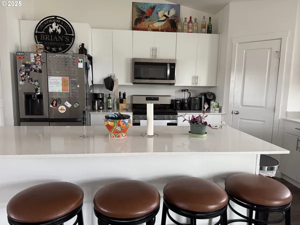 a kitchen with a sink a stove and a fireplace