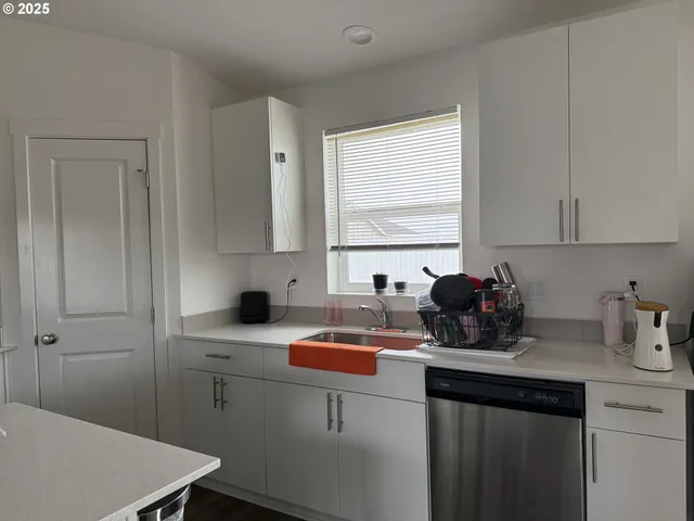 a kitchen with a sink cabinets and window