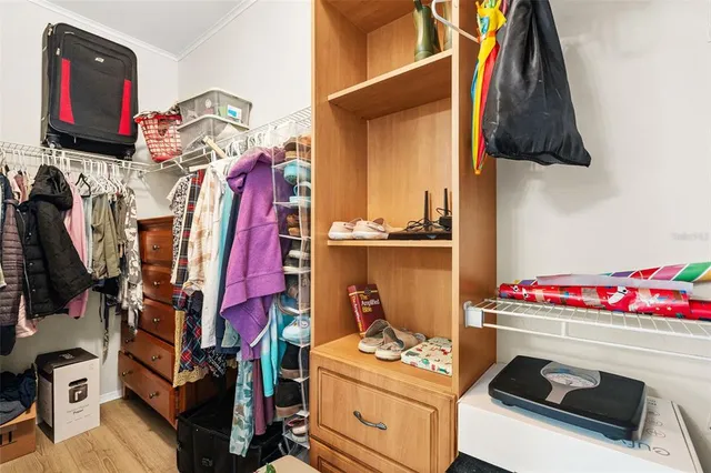 a utility room with dryer washer and shoe rack