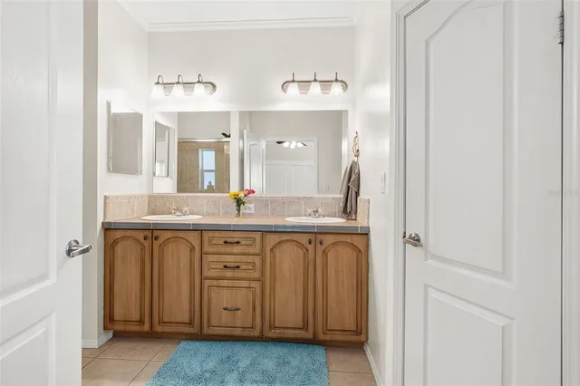 a spacious bathroom with a double vanity sink and a mirror