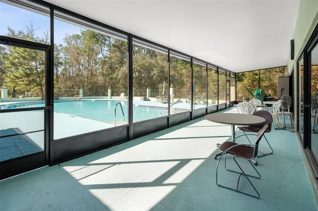 a view of a room with furniture and a large window