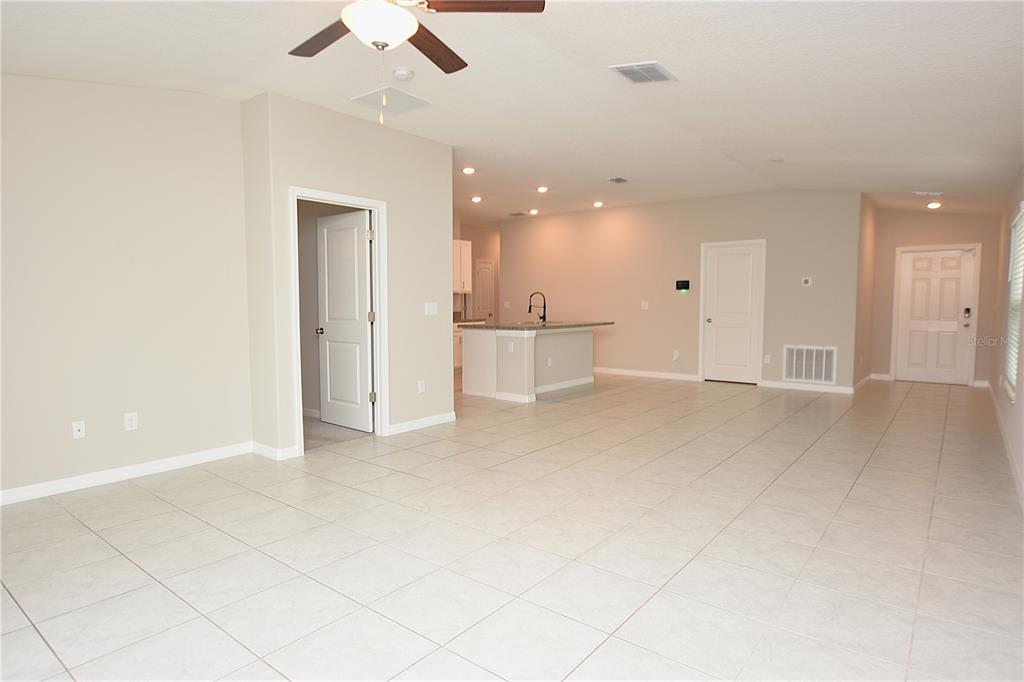 5643 Keaton Springs Drive Lakeland, FL 33811 - Photo 12 of 39 an empty room with kitchen and ceiling fan