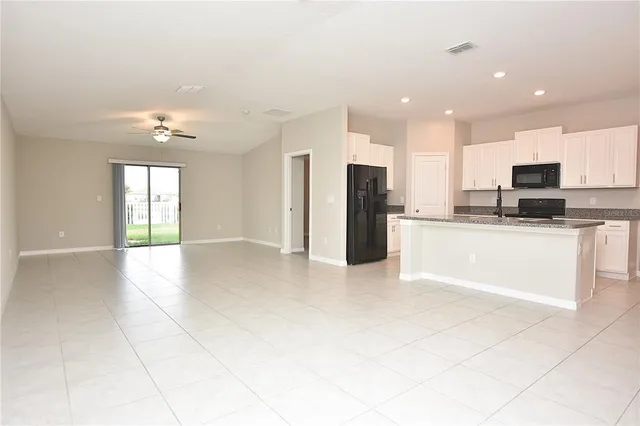 a view of a kitchen with a sink and a refrigerator