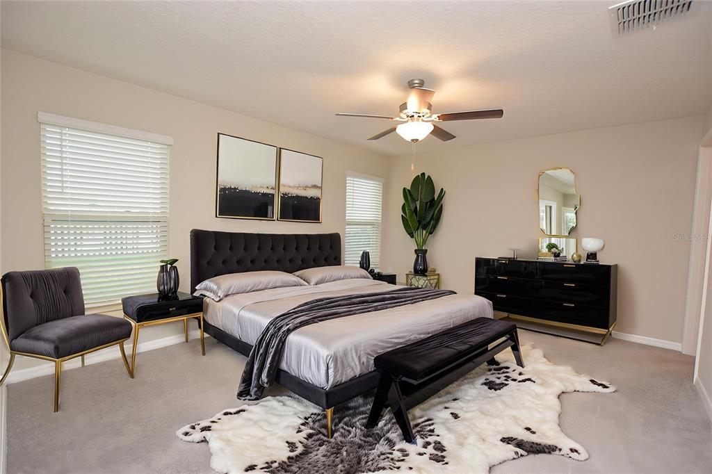 5643 Keaton Springs Drive Lakeland, FL 33811 - Photo 14 of 39 a bedroom with a bed and a chandelier