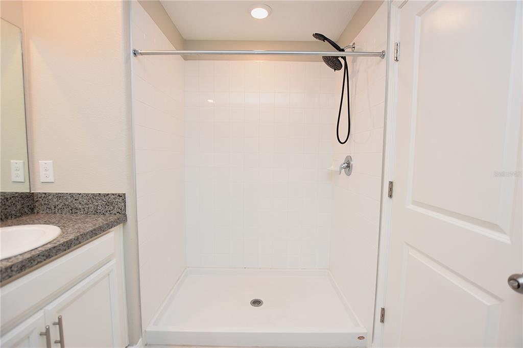 5643 Keaton Springs Drive Lakeland, FL 33811 - Photo 18 of 39 a bathroom with a granite countertop shower and a sink
