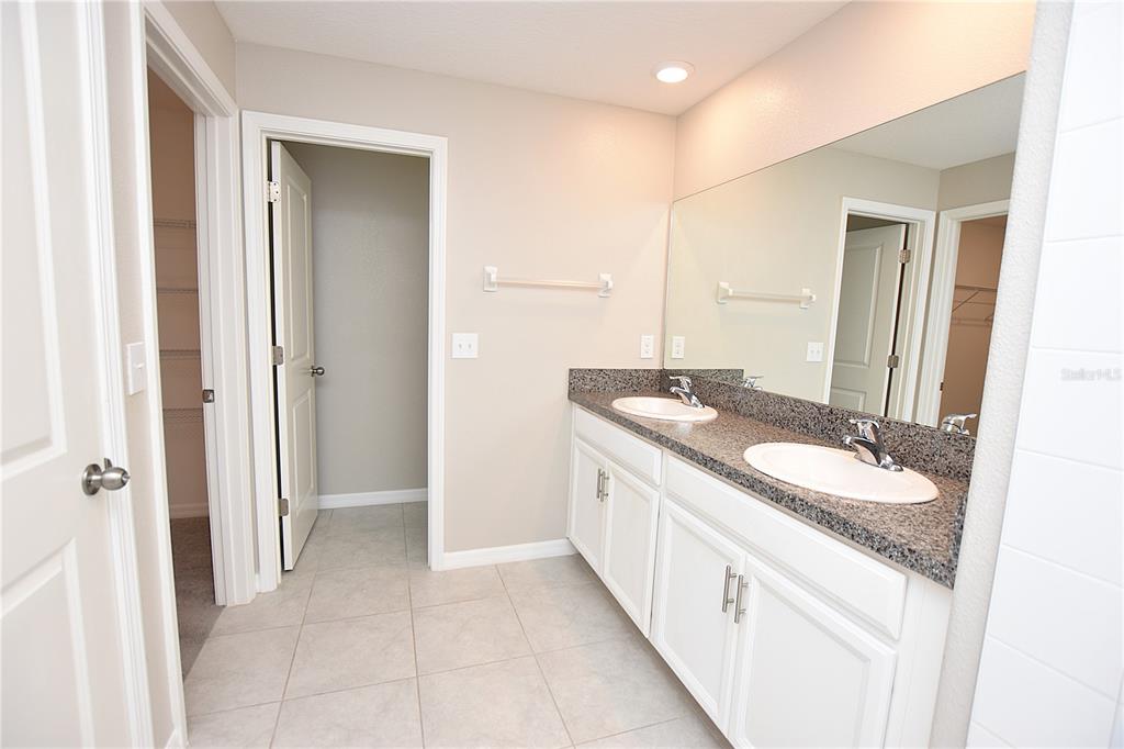 5643 Keaton Springs Drive Lakeland, FL 33811 - Photo 19 of 39 a spacious bathroom with a double vanity sink and a mirror