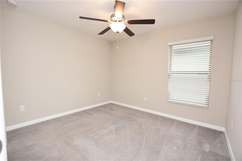 5643 Keaton Springs Drive Lakeland, FL 33811 - Photo 23 of 39 an empty room with a window and a fan