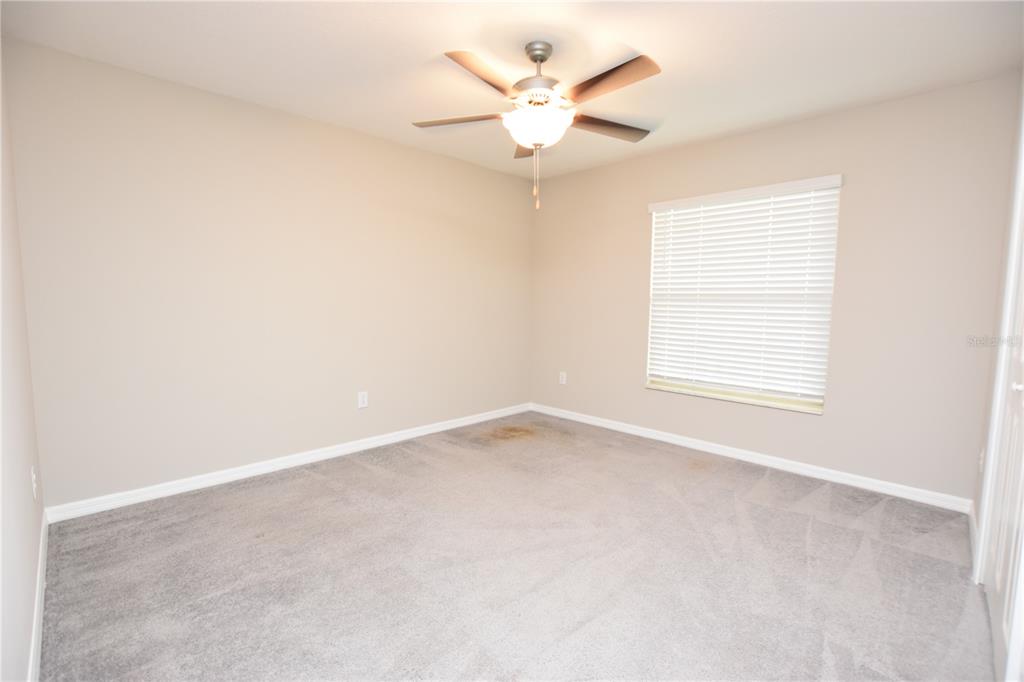 5643 Keaton Springs Drive Lakeland, FL 33811 - Photo 28 of 39 an empty room with a window and a ceiling fan