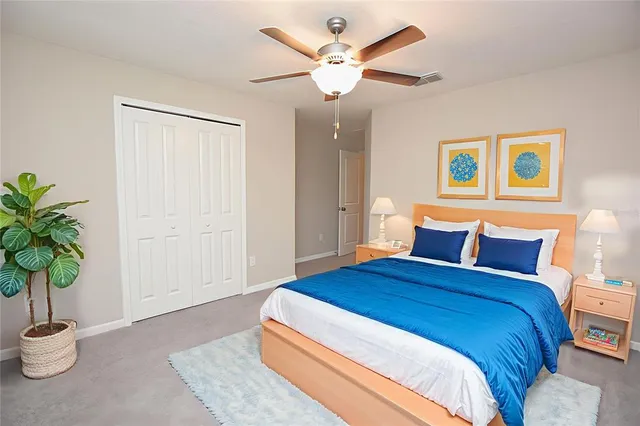 a bedroom with bed and a potted plant