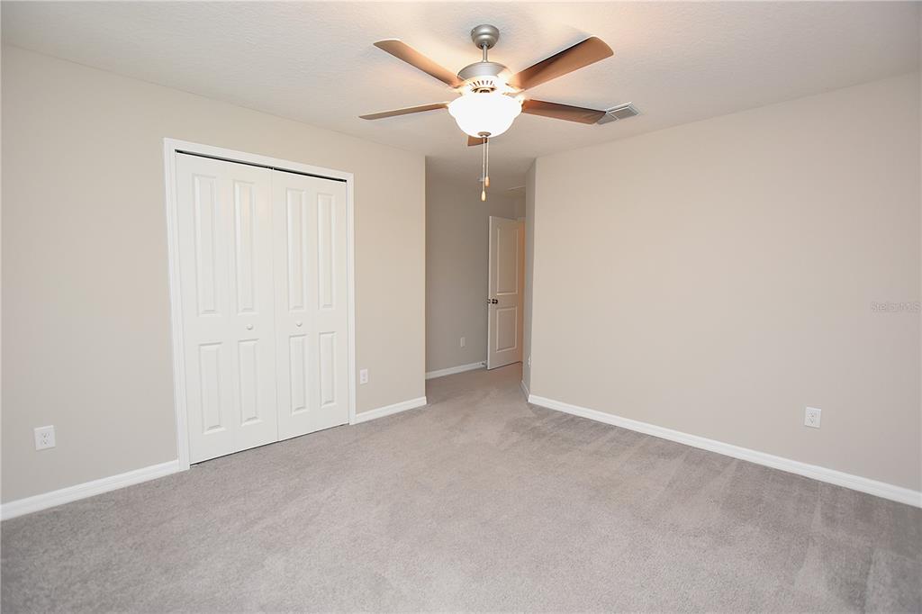 5643 Keaton Springs Drive Lakeland, FL 33811 - Photo 30 of 39 an empty room with a ceiling fan and a window