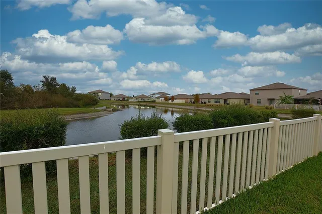 a balcony with wooden floor and lake view