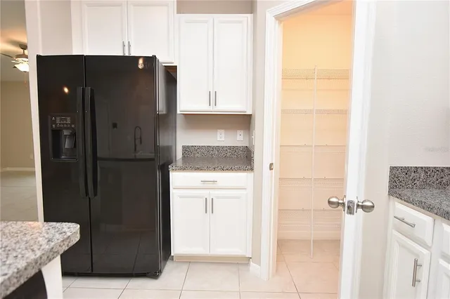 a kitchen with a refrigerator and cabinets