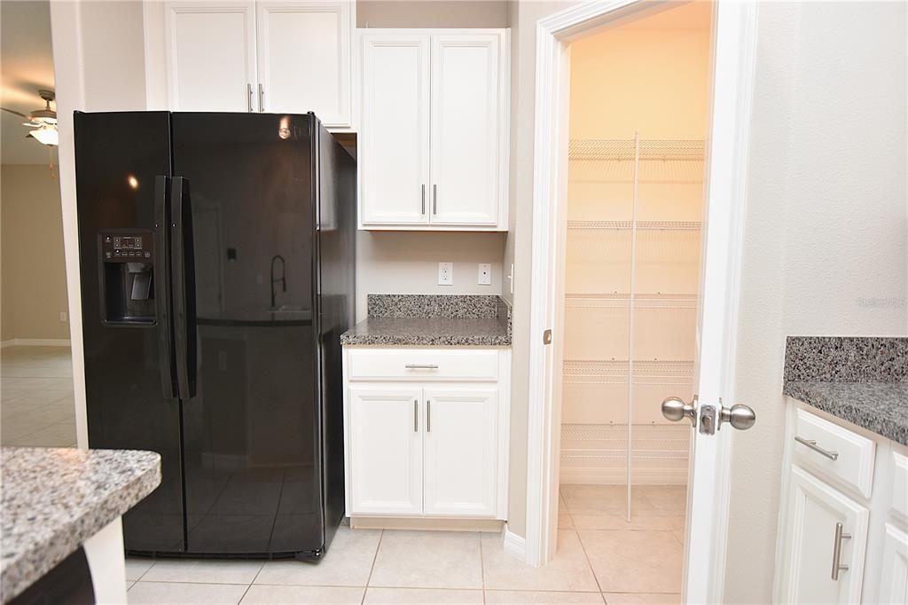5643 Keaton Springs Drive Lakeland, FL 33811 - Photo 5 of 39 a kitchen with a refrigerator and cabinets