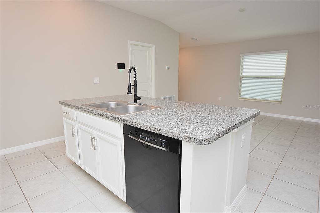 5643 Keaton Springs Drive Lakeland, FL 33811 - Photo 7 of 39 a kitchen with stainless steel appliances granite countertop a sink and dishwasher