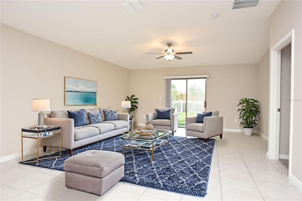 5643 Keaton Springs Drive Lakeland, FL 33811 - Photo 10 of 39 a living room with furniture potted plant and a window