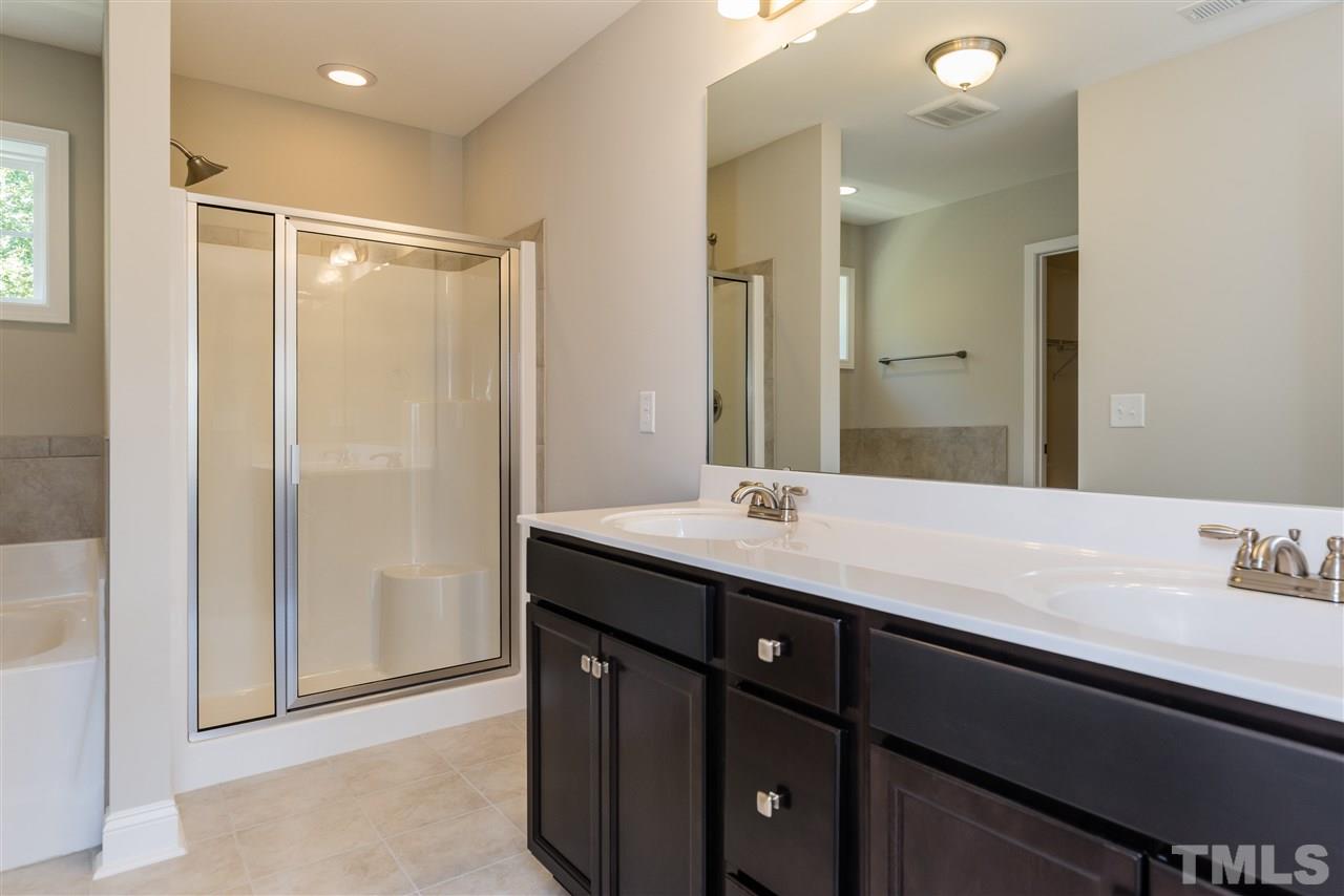 3413 Grosbeak Way Raleigh, NC 27616 - Photo 23 of 25 a bathroom with a sink and a mirror