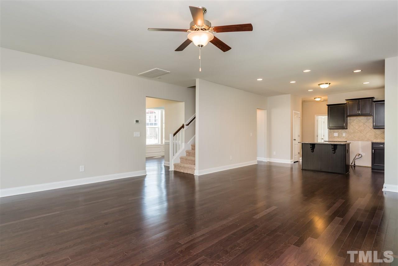 3413 Grosbeak Way Raleigh, NC 27616 - Photo 10 of 25 a view of empty room with wooden floor and ceiling fan