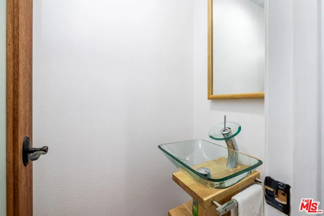 a room with a sink and a mirror