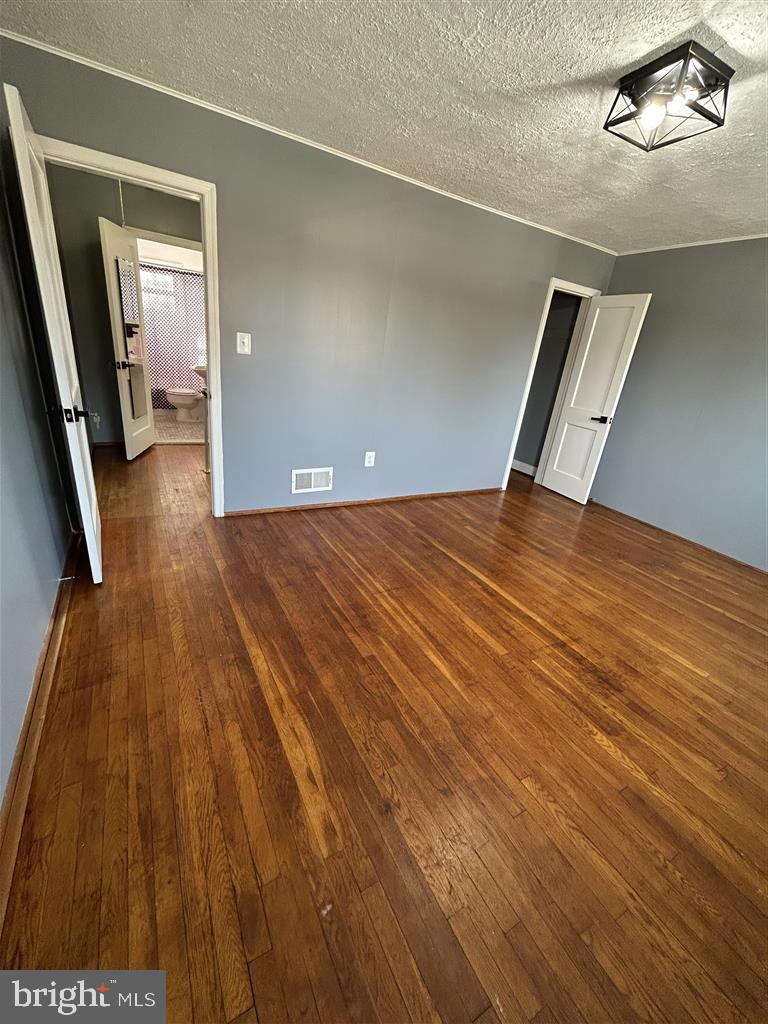 8333 Kavanagh Road Baltimore, MD 21222 - Photo 14 of 30 a view of an empty room with wooden floor
