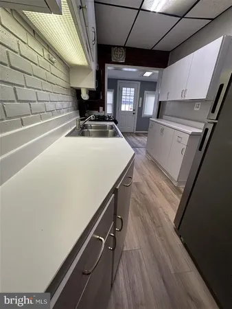 a kitchen with a sink a stove and a microwave