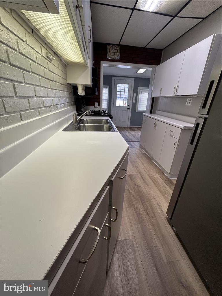 8333 Kavanagh Road Baltimore, MD 21222 - Photo 5 of 30 a kitchen with a sink a stove and a microwave