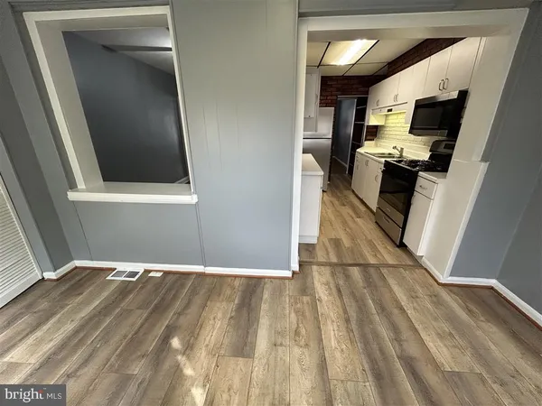 a view of a kitchen from the hallway